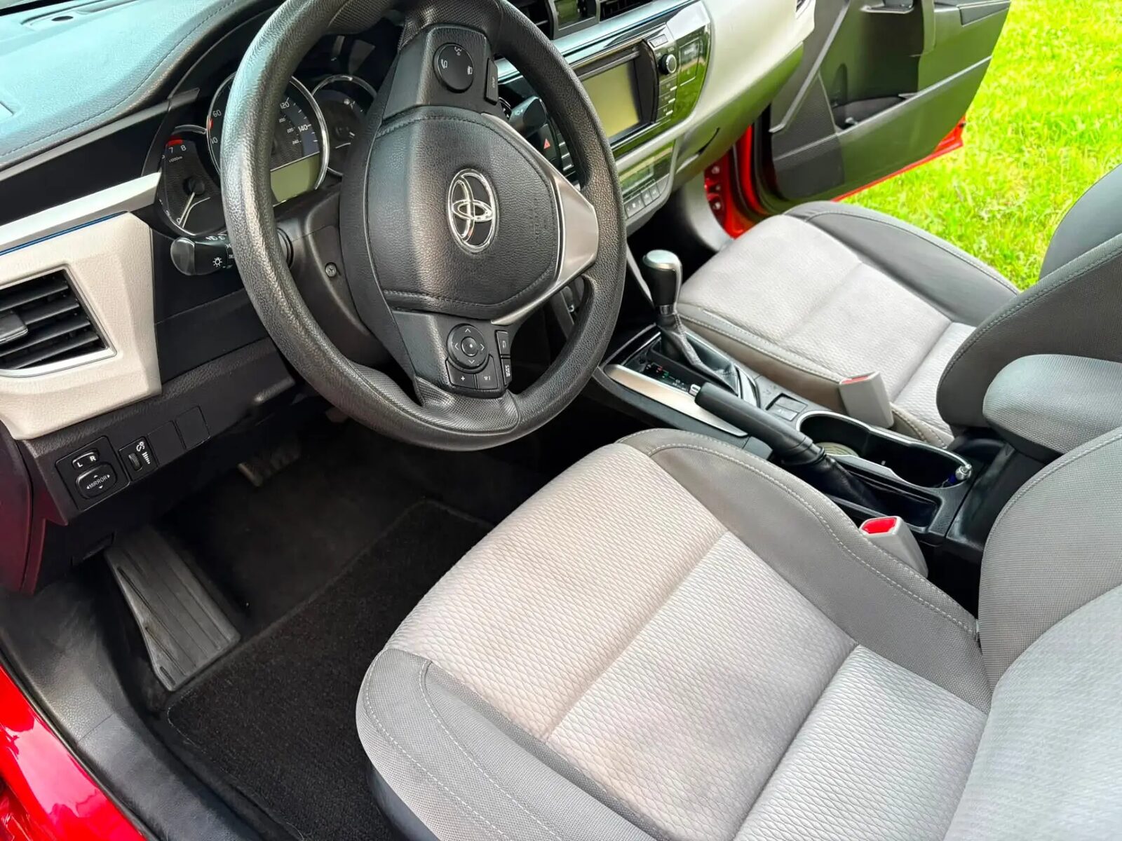 Freshly detailed Toyota Corolla front cabin with spotless cloth seats
